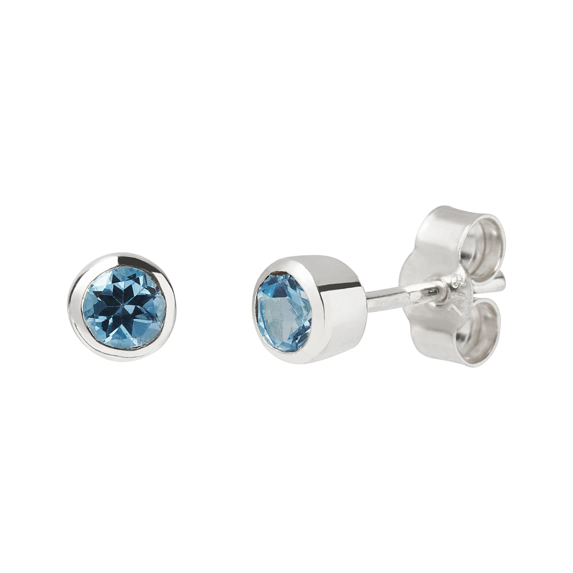 Swiss Blue Topaz 4mm faceted gemstones in a smooth rub over bezel setting stud earrings with butterfly backs on a white background, handmade at Kirsty Taylor Jewellery, Corbridge, Northumberland