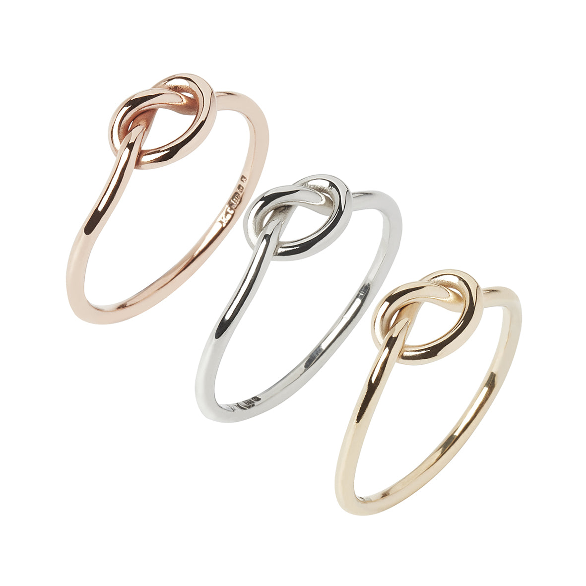 3 gold tie the knot rings, yellow, white and rose gold on a white background, Handcrafted by Kirsty Taylor in Corbridge Northumberland