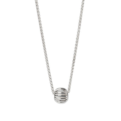 A sterling silver spherical bead with grooves inspired by a Roman Melon Bead on a silver spike chain on a white background. Made by Kirsty Taylor Goldsmiths in Northumberland