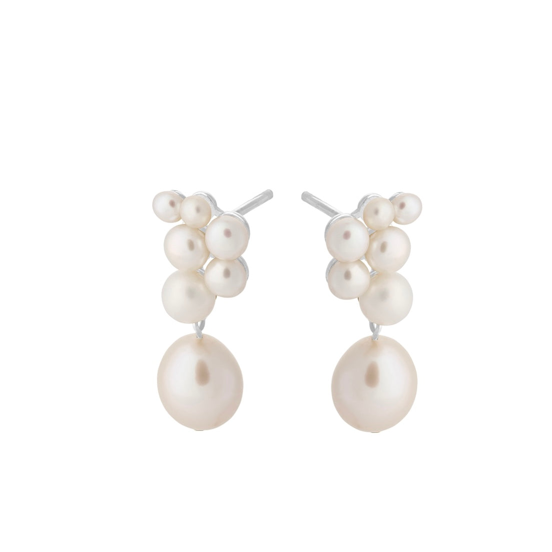 White pearl drop earrings with a cluster of white pearls in differing sizes at the stud on a white background. Ocean Treasure Earsticks by Pernille Corydon at Kirsty Taylor Goldsmiths