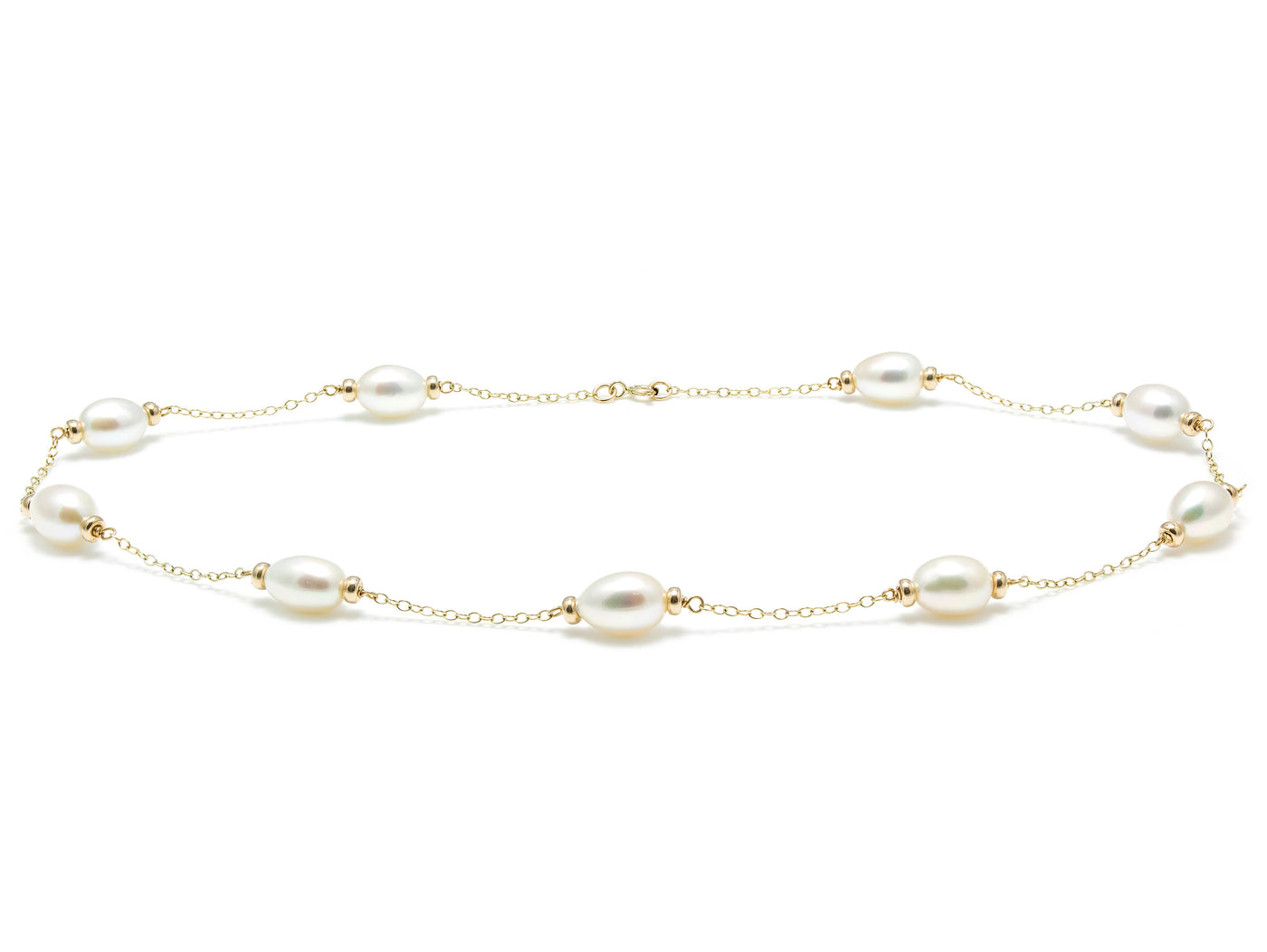 Gold necklace with pearls on a white background
