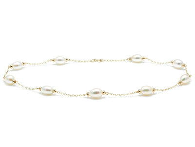 Gold necklace with pearls on a white background