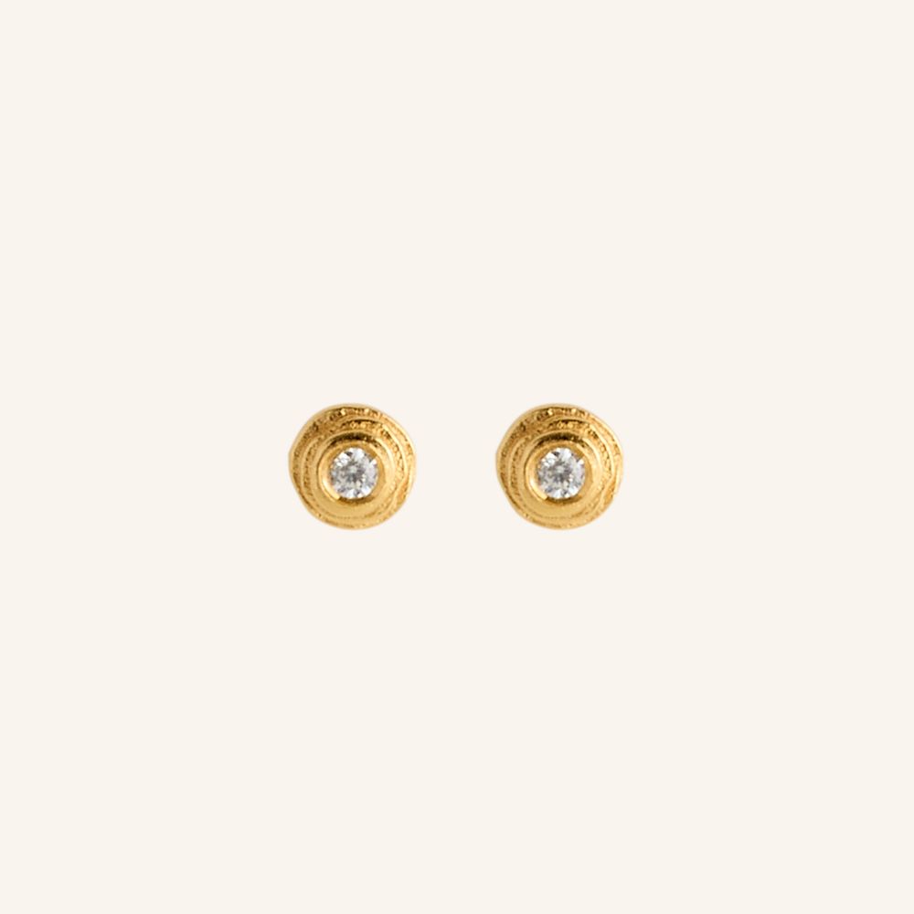 Gold earrings with embedded diamonds on a white background
