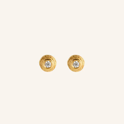 Gold earrings with embedded diamonds on a white background