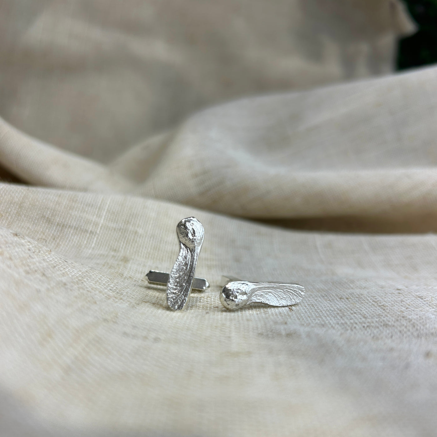 Silver Sycamore Cufflinks  on a beige fabric background handcrafted Kirsty Taylor Jewellery
