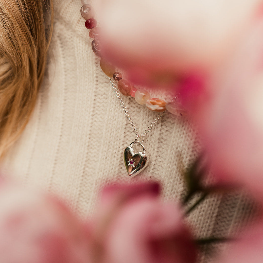 Sliver heart pendant with star set ruby ons silver chain.